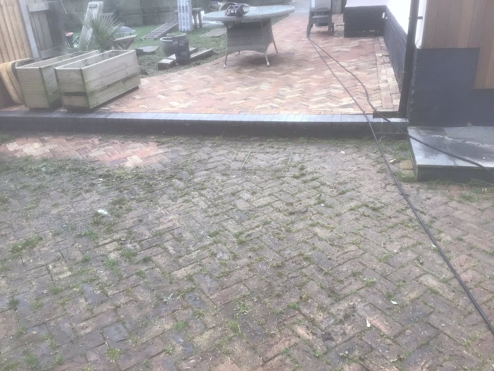 Block paving driveway half cleaned